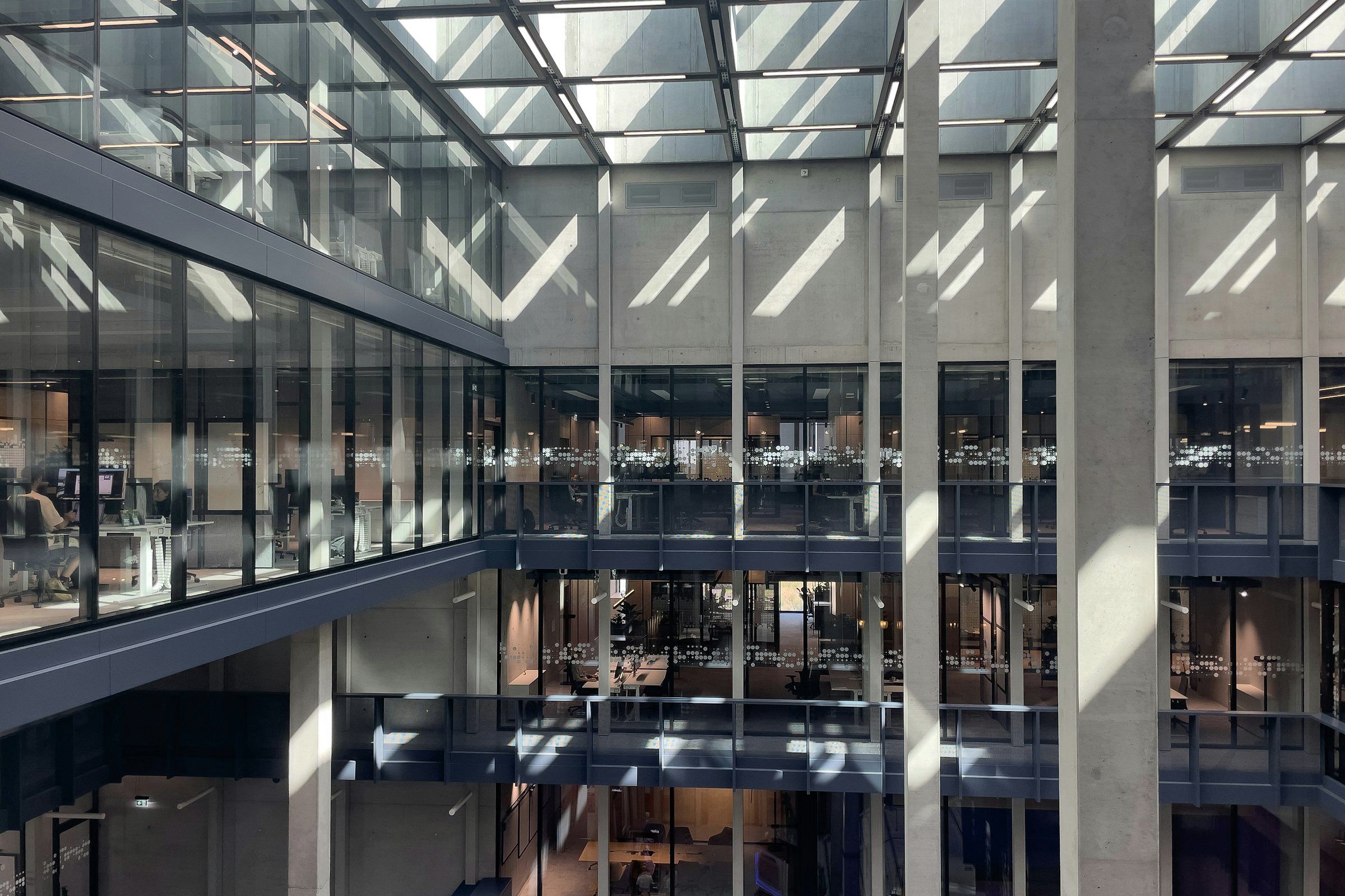 Atrium of an office building with glass facades over several floors